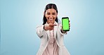 Happy woman, business and pointing to green screen of phone for advertising space, sign up offer and mockup newsletter in studio. Portrait of indian worker show mobile announcement on blue background