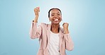 Happy black woman, fist pump and celebration for winning or success against a blue studio background. Portrait of excited African female person smile in joy for business, achievement or job promotion