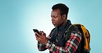 Phone, fail and angry black man in studio with travel, stress or location problem while hiking on blue background. Smartphone, criss and African male backpacker frustrated by 404, glitch or app error