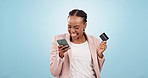 Black woman, phone and credit card for online shopping, excited for store discount and payment success. Finance, ecommerce and fintech, cheers for customer experience in studio on blue background