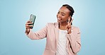 Selfie, peace sign and a black woman on social media with a blue background for a video call. Smile, fun and an African girl taking a photo on a mobile with an emoji sign for communication or app