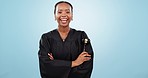Judge woman, face and arms crossed in studio with smile, gavel or happy for justice by blue background. Magistrate, law expert and hammer for decision, legal negotiation or portrait for courtroom job