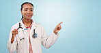 Doctor, pointing or pregnancy test with black woman, promotion or healthcare on blue studio background. Portrait, African person or professional with hand gesture, pregnant testing or medical results