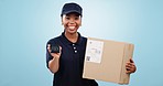 Happy black woman, box and pos machine for payment, delivery or purchase against a studio background. Portrait of female person or courier lady smile with parcel, package or cargo for transaction
