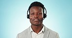 Callcenter, communication and contact us, black man and phone call with telecom or customer service on blue background. Portrait, help desk and talk for telemarketing sales and consultant in studio
