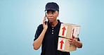 Delivery, stress and phone call by woman in studio with box, order or cargo crisis on blue background. Distribution, fail or lady courier with smartphone conflict for logistics, mistake or disaster