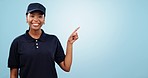 Happy black woman, pointing and deal in advertising or marketing against a blue studio background. Portrait of African female person or employee showing notification, sale or discount on mockup space