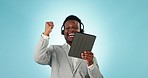 Happy black man, tablet and call center in celebration, winning or good news against a blue studio background. Excited African businessman, consultant or agent dancing with technology for achievement