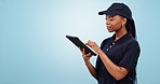 Tablet, checklist and black woman with delivery, logistics or checklist info in studio on blue background. Supply chain, schedule or female courier with digital app for stock, management or service