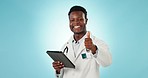 Black man, doctor and tablet with thumbs up for success, winning or good job against a studio background. Portrait of African person in medical or healthcare with technology, like emoji or yes sign