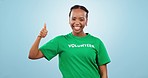 Happy black woman, volunteer and thumbs up for success or community service against a studio background. Portrait of African female person smile with like emoji, yes sign or OK for volunteering