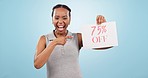 Happy black woman, billboard and discount sign for promotion or sale against a blue studio background. Portrait of excited African female person dancing with poster in celebration for deal or promo