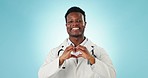 Man, heart and hands of doctor in studio for healthcare, medical support and kindness on blue background. Portrait of happy african cardiology worker, finger shape and love emoji, icon and thank you 