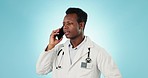 Doctor, man and talking with phone in studio for consulting, telehealth contact and communication on blue background. African medical surgeon on mobile for consultation, connect and healthcare advice