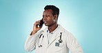 Doctor, man and communication with phone in studio for consulting, telehealth contact and speaking on blue background. African healthcare worker on mobile for consultation, feedback or medical advice