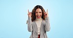 Pointing up, excited and business woman in studio with success, happy and announcement. Professional, mockup and portrait of person on blue background with hand gesture for news, promotion and emoji