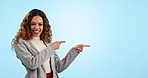 Face, pointing and woman with business, promotion and announcement on a blue studio background. Mockup space, portrait and employee with hand gesture, model and presentation with worker and winner