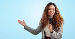 Talking, reporter and woman with news broadcast, presentation and hosting tv show on blue background in studio. Television, journalist and portrait with gesture to announcement information or mockup