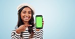 Pointing, green screen and woman with cellphone in studio with mockup space for marketing. Tracking markers, mock up and portrait of Indian female model with phone with chroma key by blue background.