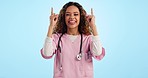 Studio, happy woman or doctor pointing up for advice on healthcare, health insurance or offer. Smile, help and excited nurse showing review, feedback or medical info in medicine on blue background.