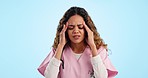 Headache, nurse and pain of woman in studio with burnout, stress and medical mistake on blue background. Frustrated, depressed and tired doctor with fatigue, migraine and risk of healthcare challenge