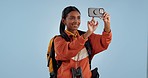 Woman, phone and backpack for photography, travel or memory of adventure against a studio background. Female person, hiker or tourist taking picture or live streaming with mobile smartphone on mockup