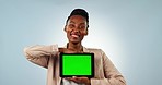 Happy black woman, tablet and green screen in advertising or marketing against a studio background. Portrait of African female person or employee smile showing technology app, display or mockup space