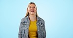 Young, woman and laugh with happiness in studio on blue background for mockup. Caucasian, model or person with confidence, smile or excitement for vacation, holiday or wellness in pose, stand or face