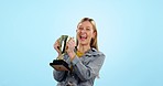 Woman, trophy celebration and smile in studio for study achievement, goal or winning by blue background. Girl, student and excited with prize, award and success in college, university or academy