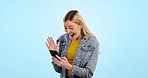 Video call, woman and smartphone with wave for communication, hello and happiness in studio on blue background. Phone, person and excited face for conversation, hi and talking online with technology