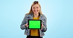 Woman, tablet and happy with green screen in studio, promotion or brand review for app by blue background. Girl, student and face with digital touchscreen, mockup or space for logo, sign and feedback