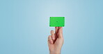 Hands, green screen and business card on mockup space in studio isolated on a blue background. Tracking markers, advertising and closeup of credit, plastic or banking for payment, marketing and promo