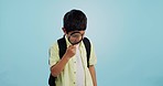 Search, looking and a child with a magnifying glass on a blue background for inspection or education. Studying, learning and a boy kid with tools for research, detective work or curious with a lens