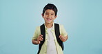 School, happy or face of child in studio on blue background ready for class, learning and education. Student, smile or portrait of a young boy with bag excited for lesson, academy or kindergarten