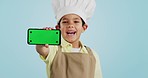 Chef kid, face or phone green screen in studio for social media, cooking tutorial ads or download. Blue background, space or happy child with notification for online marketing, mockup or advertising