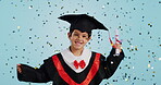 Graduate, child and celebration with confetti and happy dance in studio on blue background for education. Development, kid and success with excited expression, diploma or certificate for achievement
