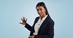 Business woman, news anchor and pointing on mockup for broadcast or weather report against a studio background. Portrait of female person, journalist or reporter showing forecast, data or information