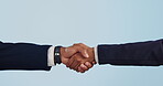 Business people, shaking hands and studio deal, partnership or financial agreement, onboarding and thank you. Professional clients handshake for meeting, introduction or support on a blue background