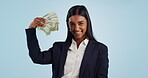 Business woman, money fan and cash bonus, financial investment or profit and professional winning in studio. Face of indian person, entrepreneur or winner in savings, cash or sales on blue background