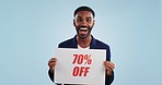 Discount price sign, man and excited face from shopping deal, promotion and poster in studio. Happy, portrait and smile with sale announcement promo on paper for advertising with blue background