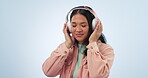 Studio music, dance and relax woman listening, streaming and enjoy radio podcast, playlist track or media song. Audio headphones, sound and dancer freedom, wellness and eyes closed on blue background