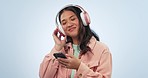 Studio music, phone and happy woman dancing, listening and streaming radio podcast, online song or media app playlist. Audio headphones, mobile smartphone and dancer wellness sound on blue background
