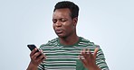 Phone, problem and frustrated man in studio with network delay, scam or spam notification on blue background. Smartphone, fail and angry African male model annoyed with  glitch, phishing or hacker