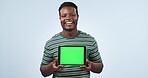 Man, face and green screen space on tablet in studio for advertising information about us on blue background. Portrait, happy african model and digital marketing of UX promotion, newsletter or launch
