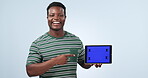 Tablet screen, happy black man and pointing at brand, online logo design or commercial mockup space, news or deal. Portrait, tracking markers and studio person show graphic offer on blue background