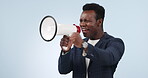 Announcement, megaphone and angry man shouting on speaker noise isolated in a studio blue background. Instructions, giveaway and loud person with sound or chant for protest for business equality