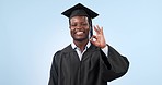 Face, ok sign and black man with graduation, smile and achievement on a blue studio background. Portrait, student or African person with degree, perfect symbol and feedback with support or excellence