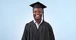 Face, funny and black man with graduation, smile and achievement on a blue studio background. Portrait, student and African person with degree, university and model with humor, laughing or excellence