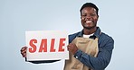 Happy black man, billboard and sale sign on discount price or promotion against a studio background. Portrait of African male person or employee smile with poster for deal, store promo or advertising