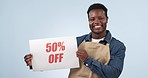 Happy black man, billboard and discount price on special promotion against a studio background. Portrait of African male person or employee smile with poster for deal, store promo or advertising sale